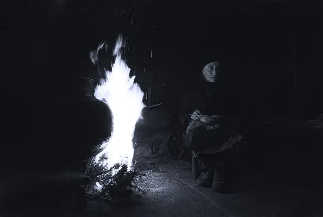Sra Serafina do Roquiño, sentada al lado de la Lareira, con la Cunca del caldo, al lado del fuego el pote de hierro fundido que servia para tener agua caliente para los humanos y animales